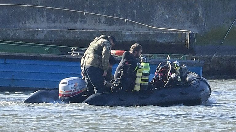 Royal Navy bomb disposal divers on a boat in King V George Dock close to London City Airport 