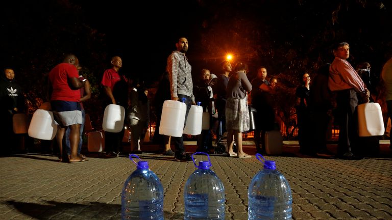 People queue to collect water from a spring in the Newlands suburb as fears over the city&#39;s water crisis grow in Cape Town, South Africa, January 25, 2018