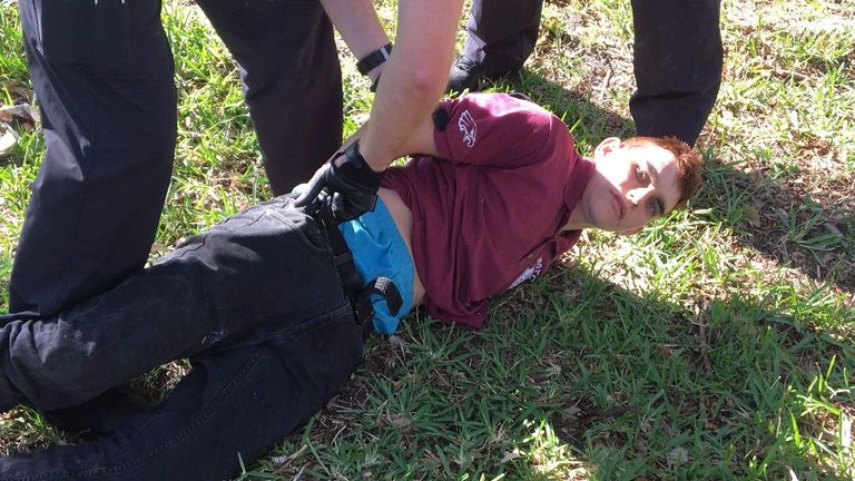 Police detain Nikolas Cruz at the scene of the Parkland school shooting