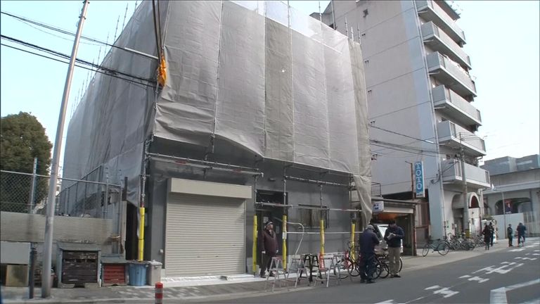 A police officer outside the building where a woman's head was found in Kyoto