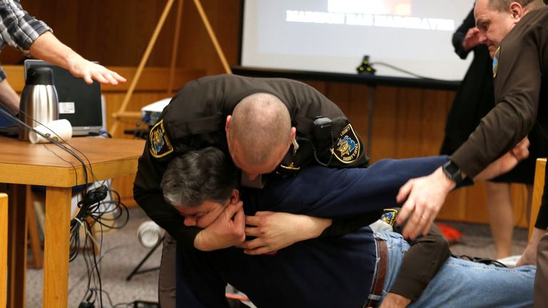 Eaton County Sheriffs restrain Randall Margraves after he lunged at Larry Nassar