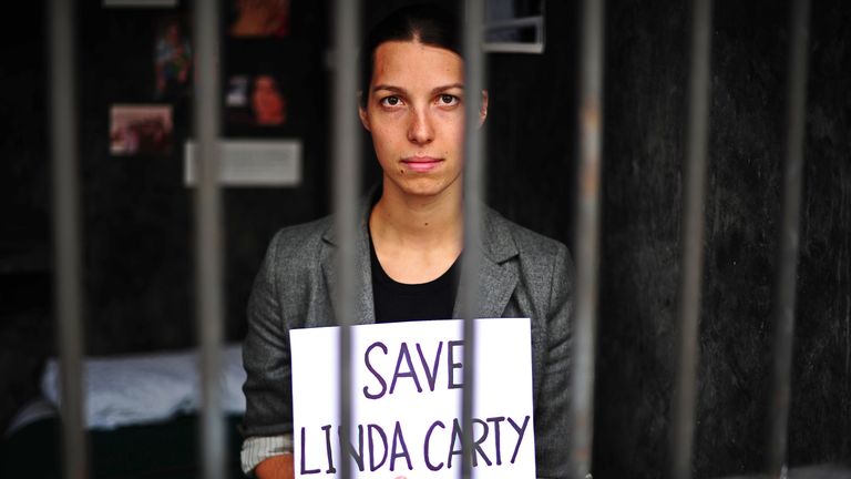 An employee of legal action charity, Reprieve holds a sign which reads &#39;Save Linda Carty&#39; during a protest in a mock prison cell, in London on August 12, 2010. The charity has created a life-size death row cell which they are encouraging visitors to spend 15 minutes in. The event is designed to highlight the plight of British prisoner, Linda Carty who is on death row in the U.S after she was convicted for comitting a murder on May 16, 2001. The cell will be on show from August 12, 2010 to Septem