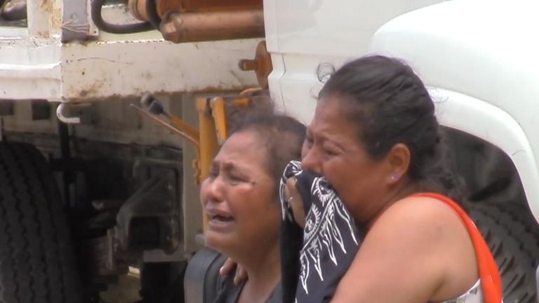 Local women mourn at a crime scene