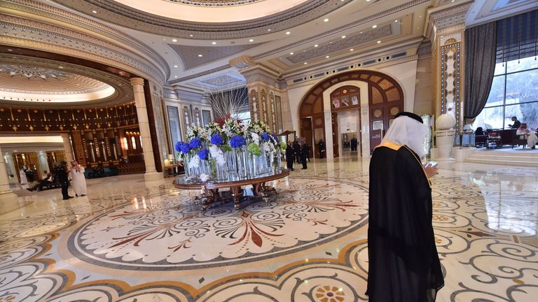 US and Saudi officials walk in the hallway of the Ritz Carlton hotel in the capital Riyadh on May 21, 2017, during a visit of the US president. / AFP PHOTO / GIUSEPPE CACACE (Photo credit should read GIUSEPPE CACACE/AFP/Getty Images)