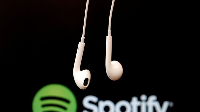 Headphones are seen in front of a logo of online music streaming service Spotify in this February 18, 2014 illustration picture