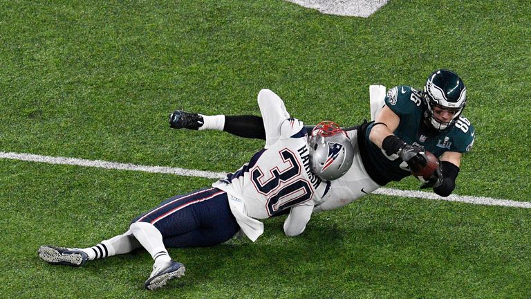 Zach Ertz of the Philadelphia Eagles makes a catch as he is tackled by Duron Harmon of the New England Patriots