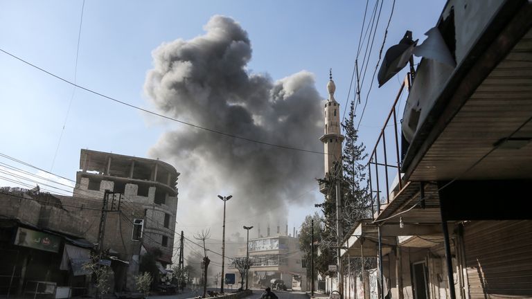 A smoke plume rises following an airstrike in Ghouta