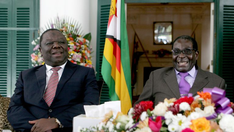 Zimbabwe&#39;s President Robert Mugabe (R) and Prime Minister Morgan Tsvangirai (L) announce the conclusion of the constitution making process at State House on January 17, 2013 in Harare. Mugabe said the country has concluded writing a draft constitution after all political parties agreed to the charter that is set to go for a referendum before elections this year. Mugabe and Tsvangirai formed a power-sharing government three years ago after violent and disputed polls in 2008. Their relations have 