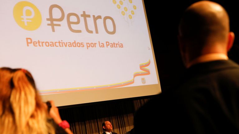 The new Venezuelan cryptocurrency the Petro logo is seen as Minister for University Education, Science and Technology Hugbel Roa talks to the media during a news conference in Caracas, Venezuela, January 31, 2018.