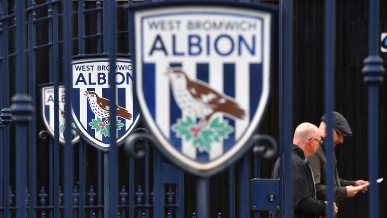 Football supporters walk past the West Bromwich Albion logo before the English Premier League match between West Bromwich Albion and Chelsea at The Hawthorns stadium in West Bromwich, west Midlands on May 12, 2017. / AFP PHOTO / Anthony Devlin (Photo credit should read ANTHONY DEVLIN/AFP/Getty Images)
