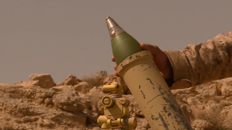 A government soldier prepares to launch a mortar in Yemen