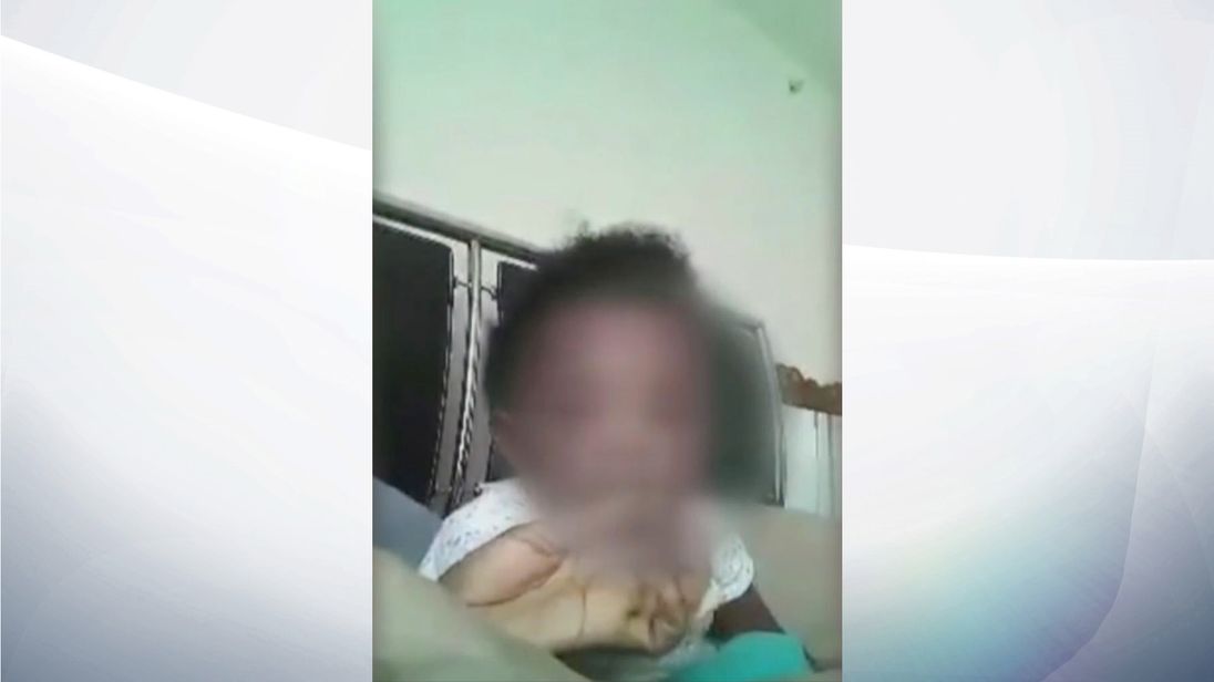 The mother appears to encourage the baby to smoke
