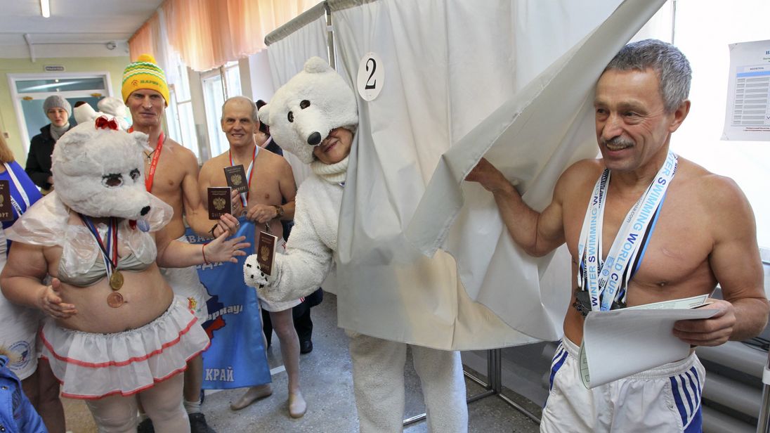 Members of the winter swimming club 'Polar Bear' visit a polling station to cast their votes during the presidential election in the Russian city of Barnaul