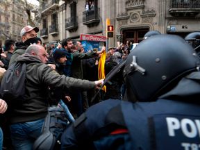 Protesters clash with officers as they are pushed back by riot police