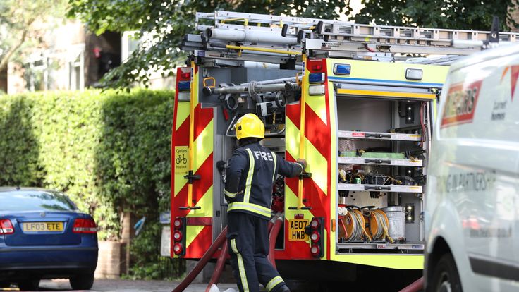 A firefighter next to an appliance in Grenfell Road,