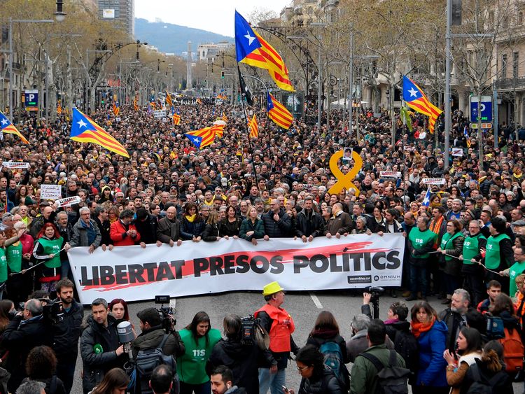 Protesters hold a banner reading: &#39;Freedom to political prisoners&#39; in Barcelona