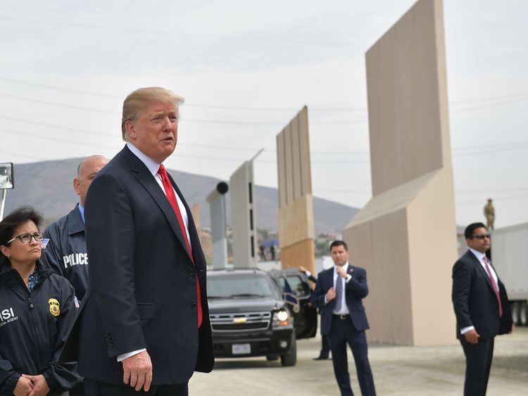 President Donald Trump (C) inspects border wall prototypes in San Diego