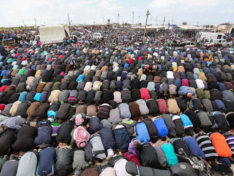 Muslim worshippers perform Friday noon prayers during a tent city protest