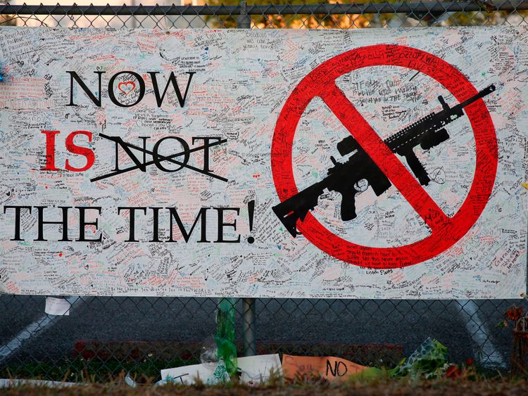 A sign hangs on a fence one at Marjory Stoneman Douglas High School in Parkland, Florida on February 27, 2018