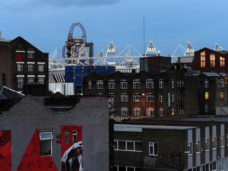 The Olympic stadium is seen beyond the rooftops of Hackney Wick