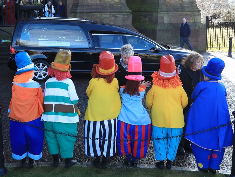 Children dressed as diddymen watch Ken Dodd's funeral cortege
