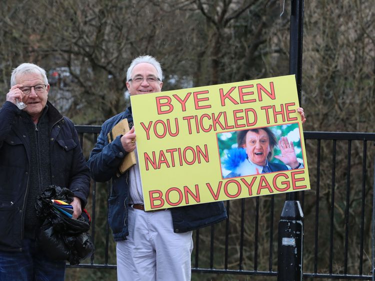 A fan of Sir Ken&#39;s holds up a tribute