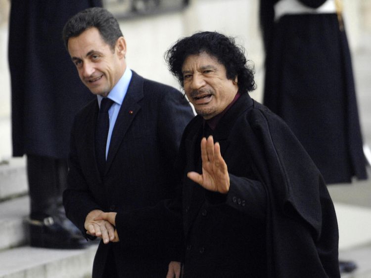 Nicolas Sarkozy (L) greets Libyan leader Moamer Kadhafi in 2007 in Paris