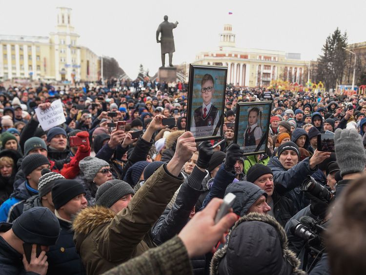 People gather to pay tribute to the victims