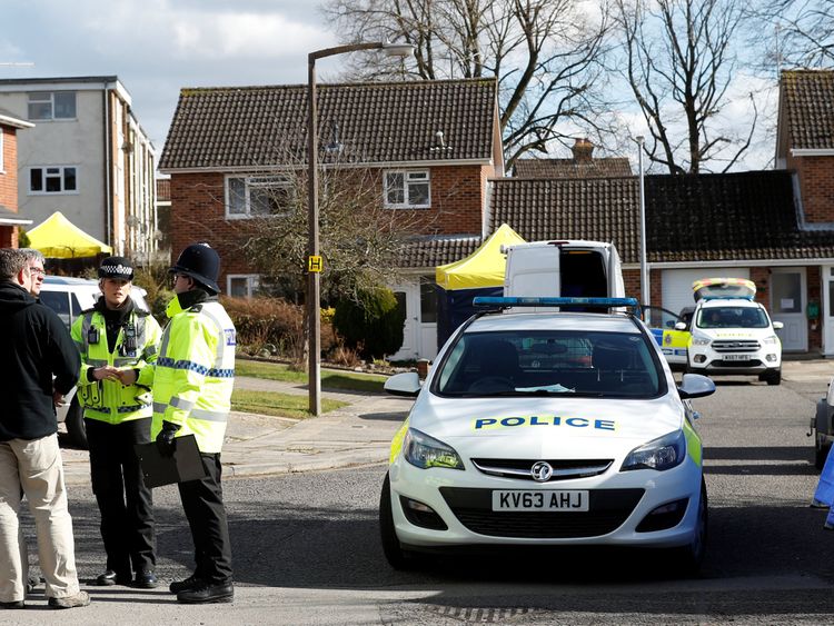 Police officers stand guard outside the home of Sergei Skripal in Salisbury