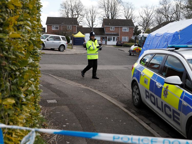 Police officers stand guard outside the home of Sergei Skripal in Salisbury