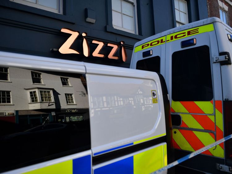Police vehicles on the pavement inside the cordon outside the restaurant Zizzi 