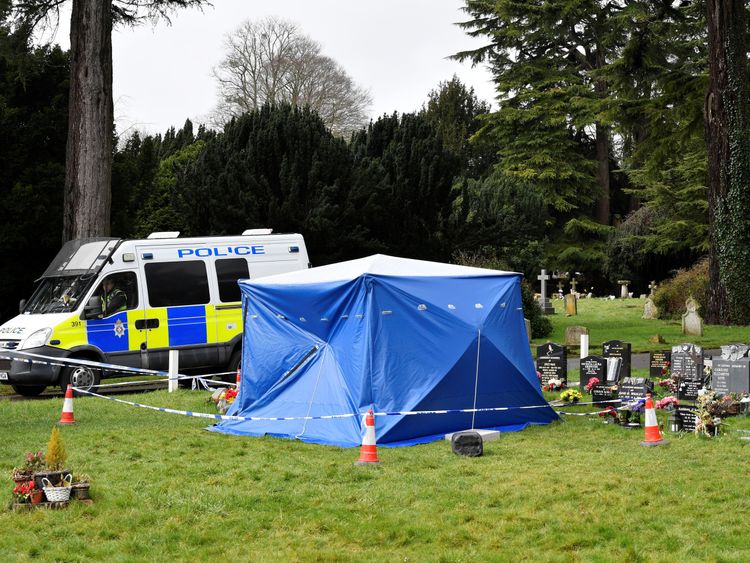 A police van is parked next to a tent covering the headstone of Alexander Skripal; son of former Russian intelligence officer Sergei Skripal in Salisbury