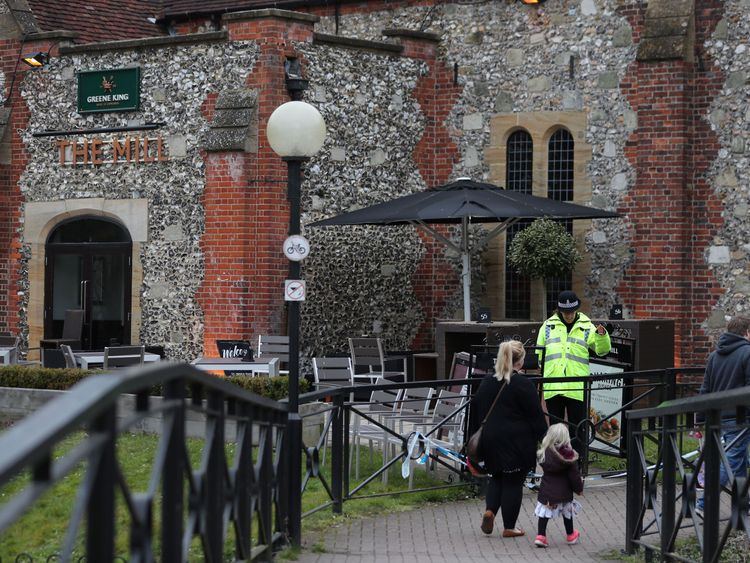 A police officer stands in front of The Mill pub in Salisbury