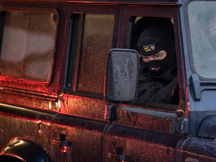 A police officer in a mask enters the Sainsbury&#39;s car park in Salisbury