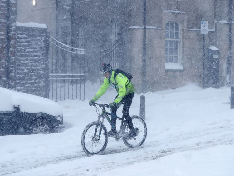 An intrepid cyclist navigates his way through the snow outside Sterling Castle in Scotland