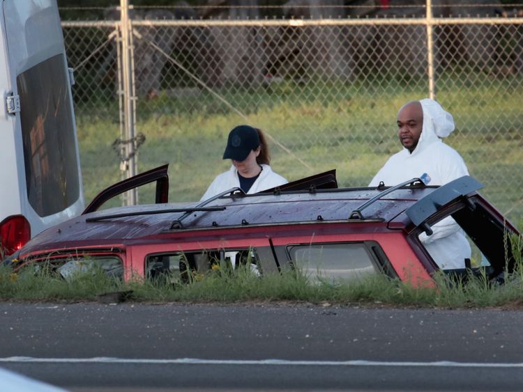 Police search the car where the suspected Texas bomber died