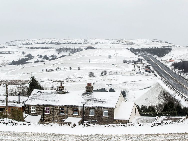 A farm house in the snow next to the M62 in Kirklees