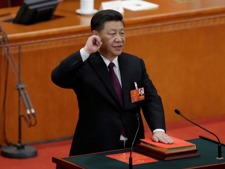 Chinese President Xi Jinping with his hand on the Constitution takes the oath, after he is voted as the president for another term, at the fifth plenary session of the National People's Congress (NPC) at the Great Hall of the People in Beijing, China March 17, 2018. REUTERS/Jason Lee