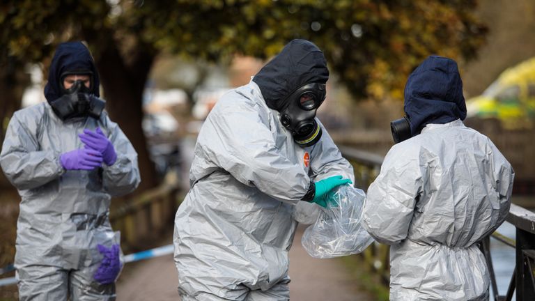 Police officers in protective suits and masks at the scene of the nerve agent attack