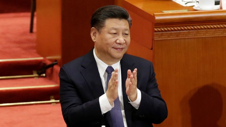Chinese President Xi Jinping applauds after the parliament passed a constitutional amendment lifting presidential term limit