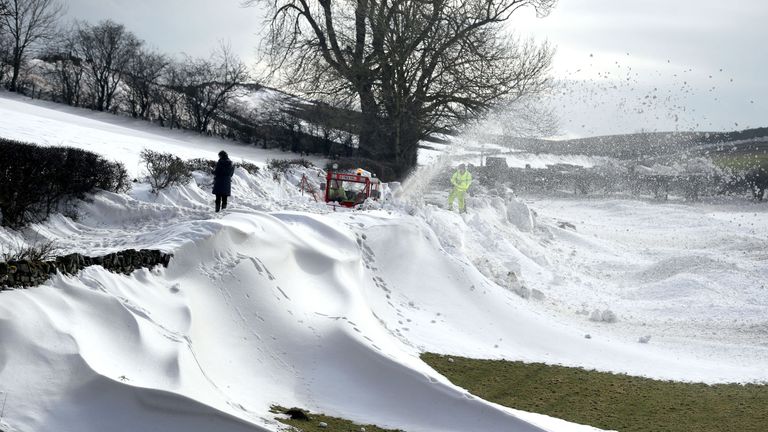 A snowblower clears the road to a small Hamlet which has been blocked since Thursday at Parkhead near Kirkoswald