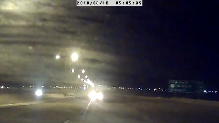 Police in Alberta, Canada, said they charged a man with impaired driving after his vehicle was filmed colliding with another car while travelling the wrong way down a motorway