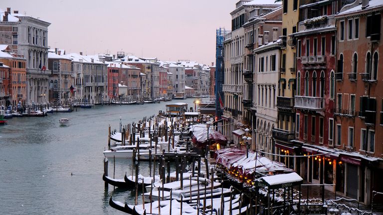 Snow covered gondola&#39;s on Canal Grande in Venice lagoon