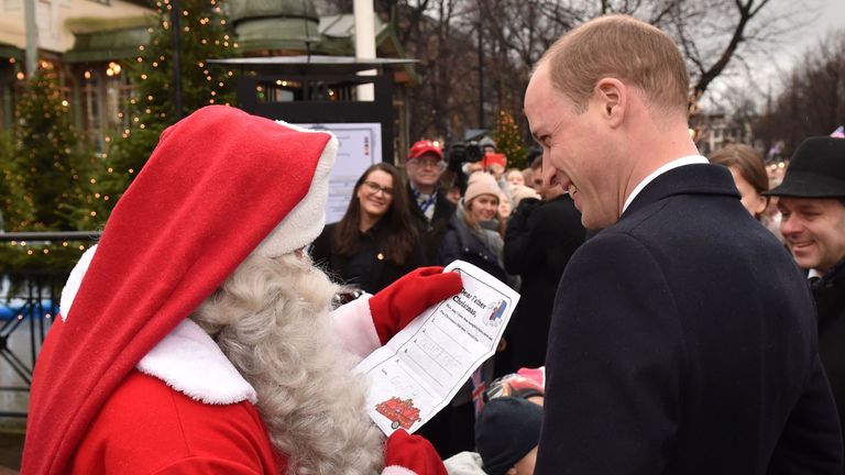 Prince William passes Santa a Christmas list from son George