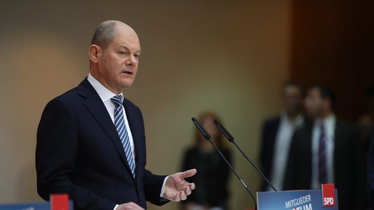 Olaf Scholz, acting chairman of the German Social Democrats, announces the vote result
