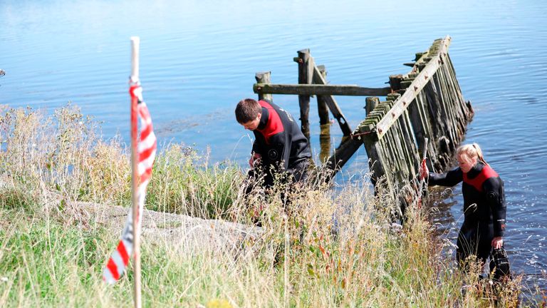 Members of The Danish Emergency Management Agency (DEMA) assist police at Kalvebod Faelled in Copenhagen on August 23, 2017 in search of missing bodyparts of journalist Kim Wall close to the site where her torso was found on, August 21