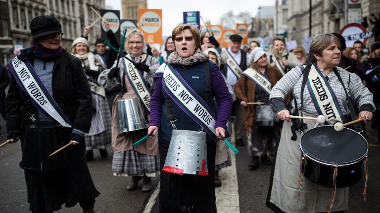 Marchers wore sashes with the suffragettes&#39; famous slogan &#39;deeds not words&#39;