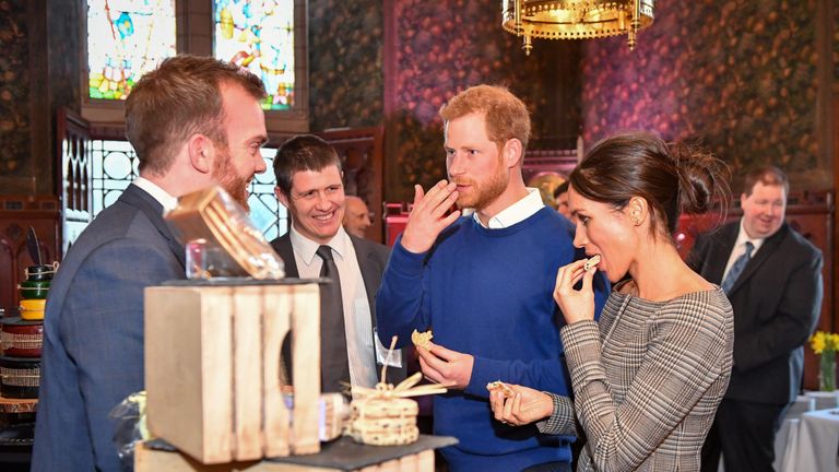 Prince Harry and Meghan Markle taste traditional Welsh cakes during a visit to Cardiff Castle