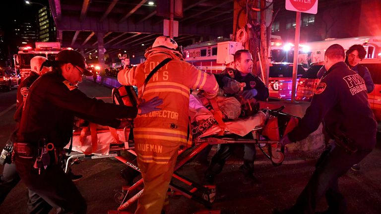 Paramedics and members of the FDNY perform CPR on a victim of a helicopter that crashed into the East River in New York, U.S., March 11, 2018