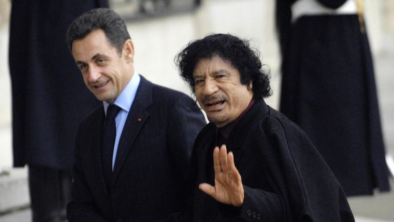 Nicolas Sarkozy (L) greets Libyan leader Moamer Kadhafi in 2007 in Paris